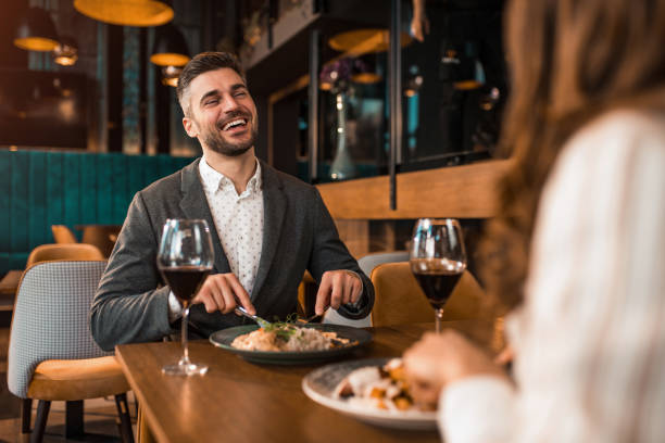 istock Happy man eating lunch with his girlfriend in a restaurant. 1375928752
