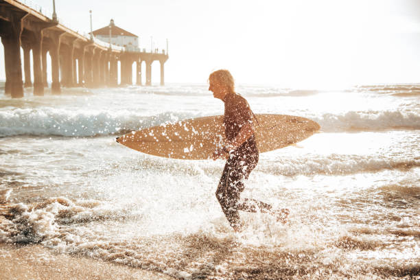 istock surfer man on manhattan beach california 1375929300