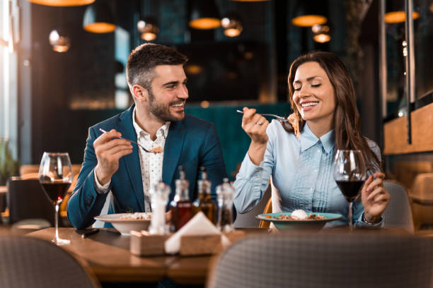 istock Happy couple eating lunch together in a restaurant. 1375929609