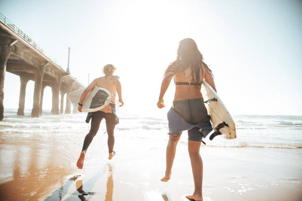 istock surfer friends resting on the beach 1375930365