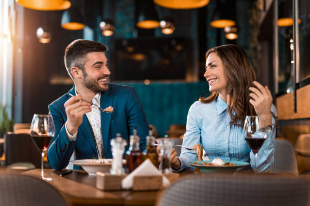 istock Happy couple eating lunch together in a restaurant. 1375930897