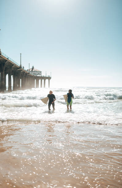 istock surfer friends resting on the beach 1375930906