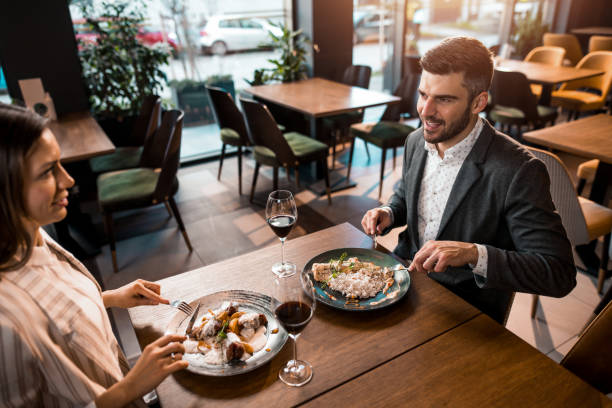 istock Happy couple eating lunch together in a restaurant. 1375930913