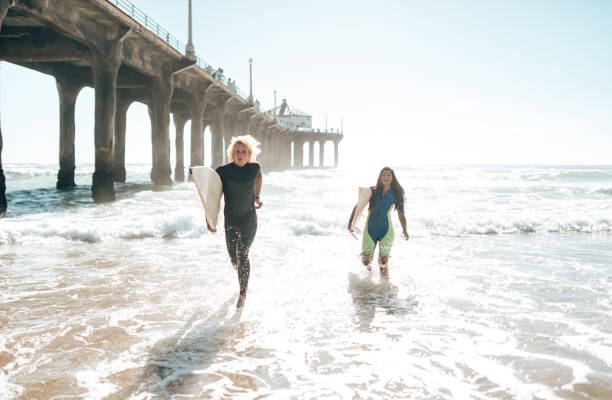 istock surfer friends resting on the beach 1375931456