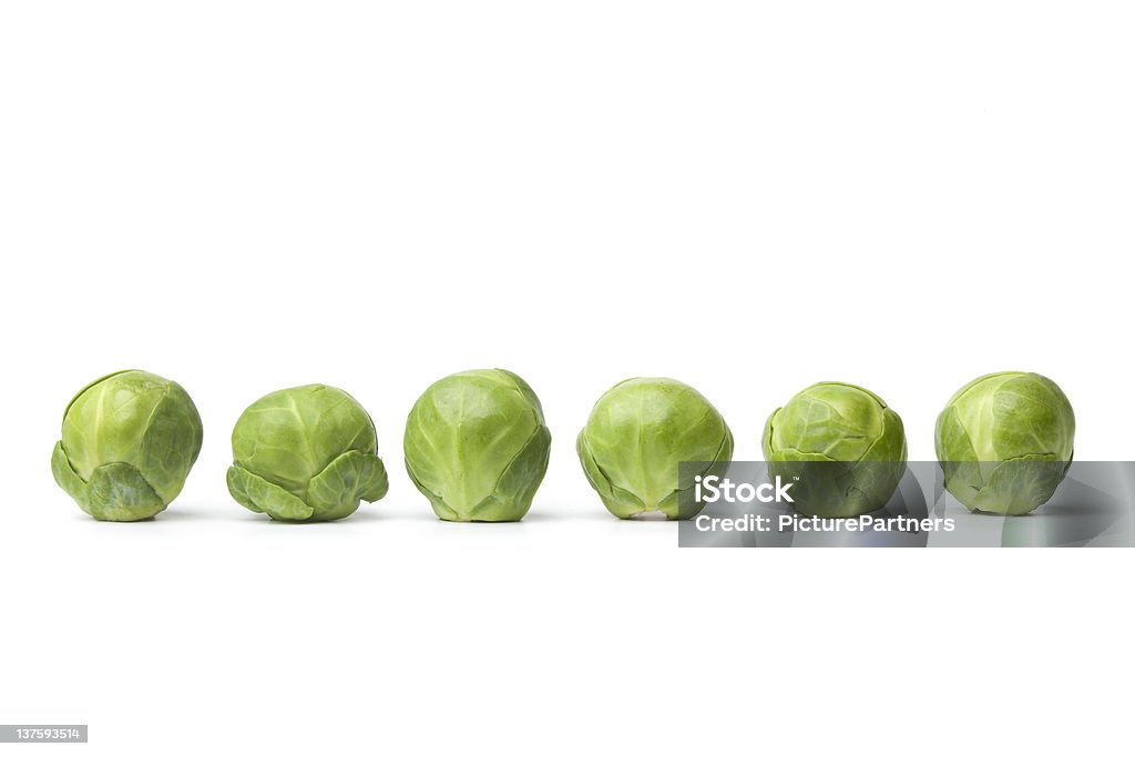 Row of fresh Brussel sprouts Row of fresh Brussel sprouts  on white background Brussels Sprout Stock Photo