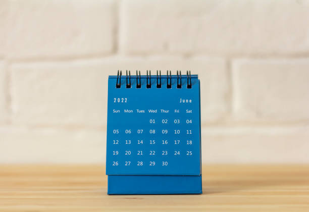 istock Desktop calendar for June 2022 on the table. 1375944052