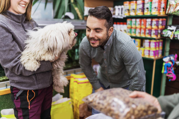 Pet shop Middle age handsome man enjoying in visit and shopping in pet shop store together with his adorable funny dog. pet shop photos stock pictures, royalty-free photos & images
