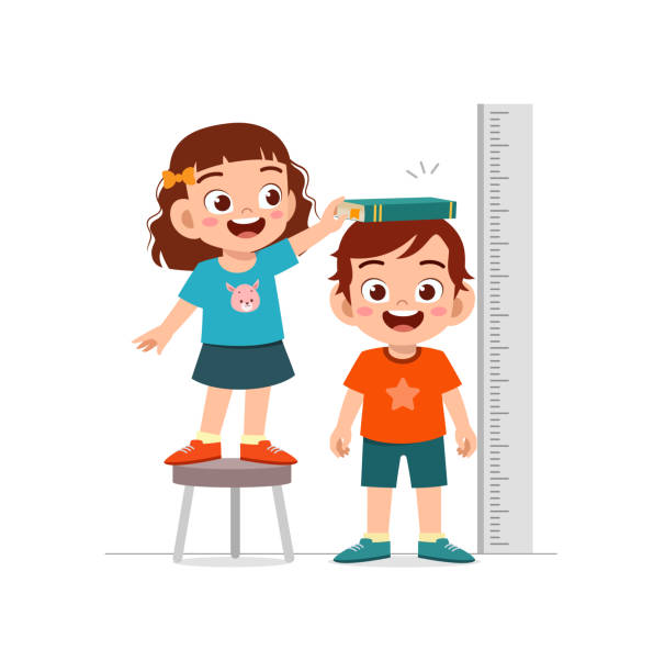 istock boy and girl measure height for grow progress 1375962705