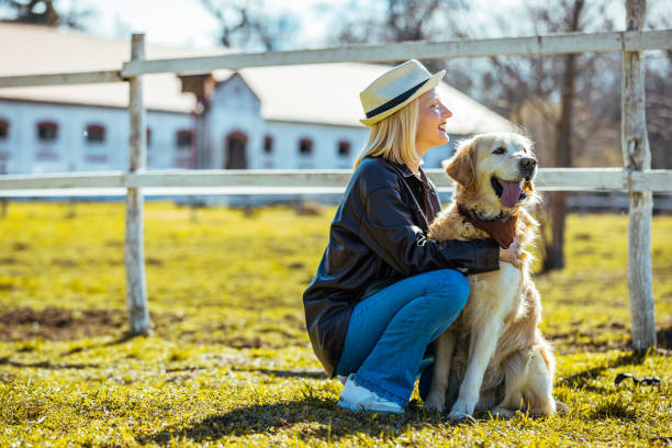 istock Smiling young woman hugging her dog 1375990882
