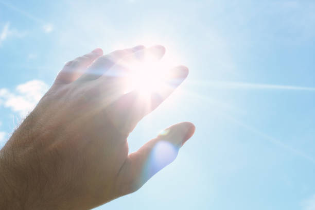 istock Hand covering the bright sun. Background. Texture. 1375997772