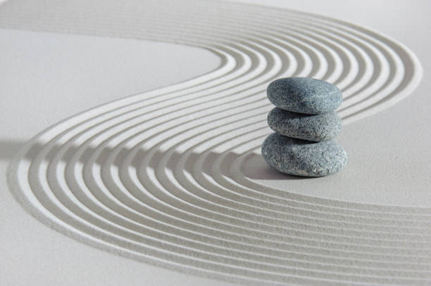 istock Japanese ZEN garden with yin yang stone in textured sand 1376005299