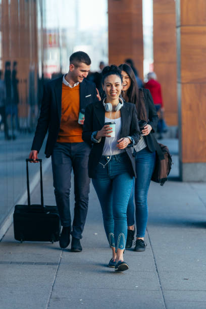 istock Friends walking together through a modern object while chatting to each other. 1376006743