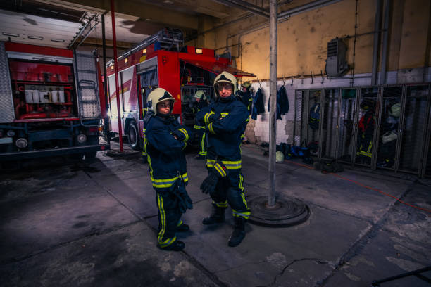 istock Firefighters preparing their uniform and the firetruck in the background inside the fire station 1376007061