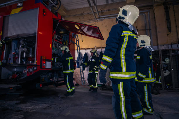 istock Firefighters preparing their uniform and the firetruck in the background inside the fire station 1376007076