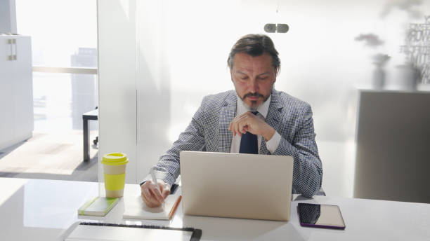 istock Mature businessman working in the office 1376007125