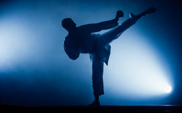 istock Young man is practicing martial arts in sport gym 1376007982