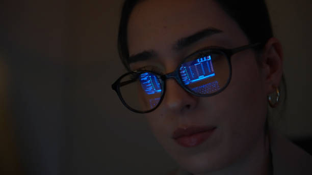 istock Financial charts reflection on a woman's eyeglasses 1376008000