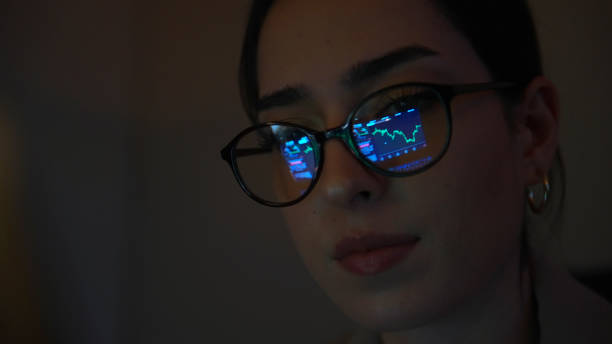 istock Financial charts reflection on a woman's eyeglasses 1376008062