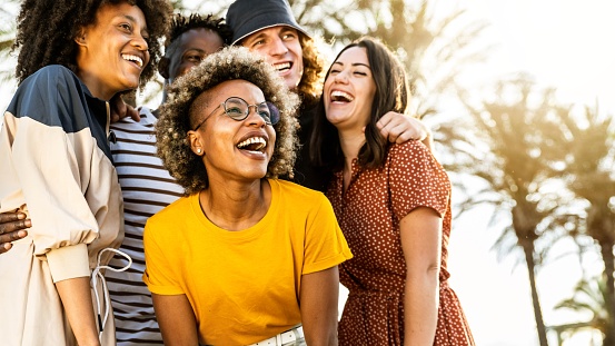 young people laughing out loud on a sunny day - Cheerful group of best friends enjoying summer vacation together - Human resources, youth lifestyle and summertime holidays concept