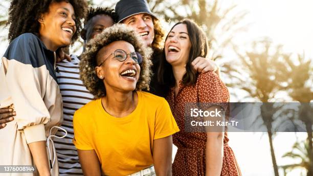 Young People Laughing Out Loud On A Sunny Day Cheerful Group Of Best Friends Enjoying Summer Vacation Together Human Resources Youth Lifestyle And Summertime Holidays Concept Stock Photo - Download Image Now