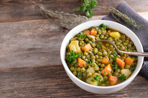 Vegetarian stew with green peas, potatoes and vegetables stock photo