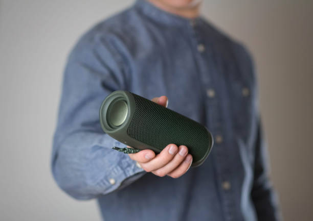 istock A man holds a portable speaker. Close up 1376048507