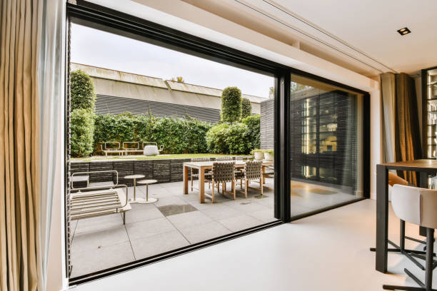 Attractive huge sliding glass door Attractive huge sliding glass door leading to the courtyard sliding door stock pictures, royalty-free photos & images