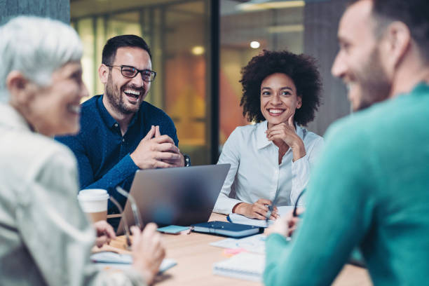 Smiling business people during a meeting stock photo
