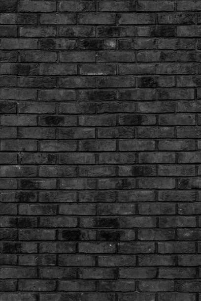 istock Black brick building wall. 1376084140