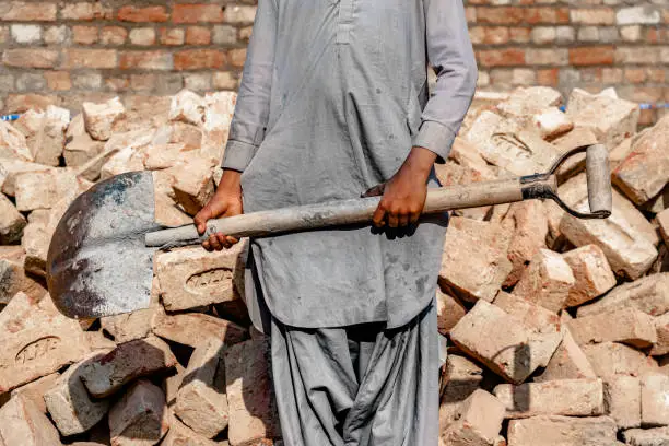 Photo of A young boy is doing child labor works