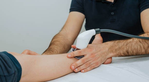 Close-up of the foot treated with ultrasound. Foot Physiotherapy Concept stock photo
