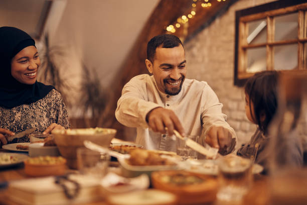 istock Happy Middle Eastern family enjoying in Ramadan dinner at dining table. 1376089924
