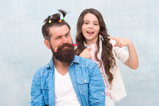 Looking good. hairdresser and barbershop. happy family day. small girl play with dad. bearded man father having fun with kid. childrens day. love and trust. daughter and father with funny hairdo.