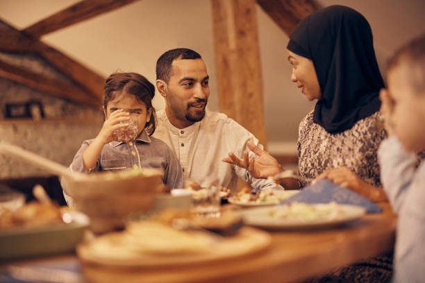 istock Happy Muslim family enjoying in conversation while having dinner at dining table on Ramadan 1376089969