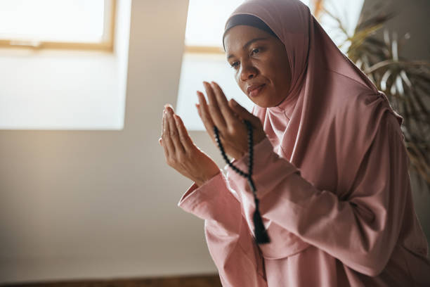 istock Black Muslim woman reciting dua while praying at home. 1376090009