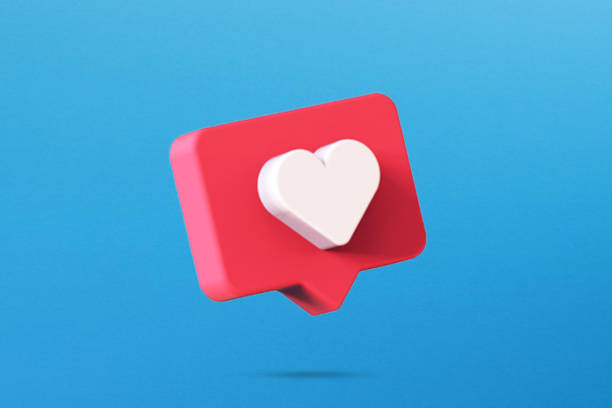 istock Red speech bubble with white heart symbol on blue background 1376091281