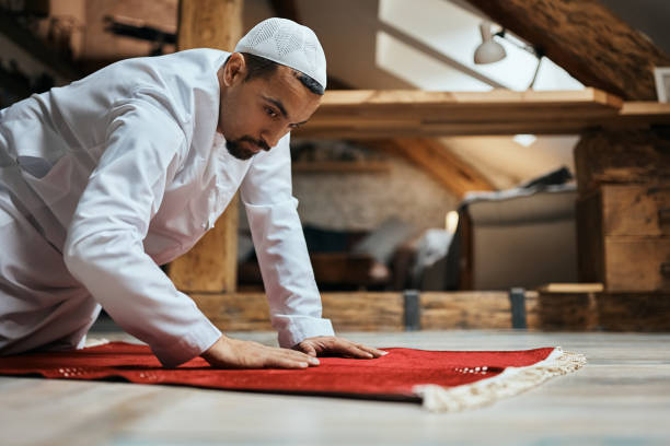 istock Muslim man placing red prayer mat on the floor. 1376092226
