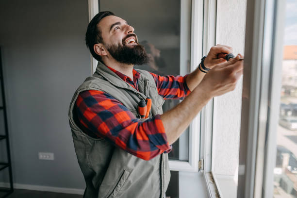 istock Handyman fixing the window 1376098700