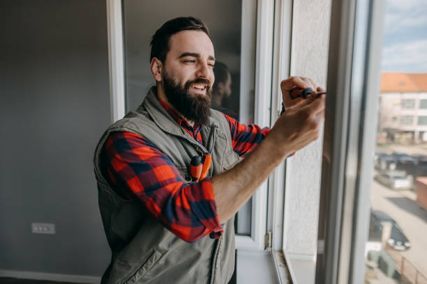 Handyman fixing the window