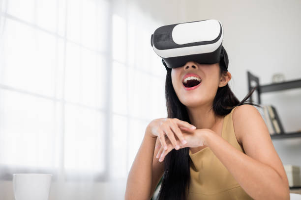 istock Young asian woman put on vr glasses into virtual simulated world. Future technology digital cyber universe. Person Enjoying an Experiences of Virtual World. 1376103577