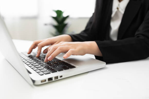 istock Close up hand woman texting on keyboard laptop work sitting working in office. 1376103603