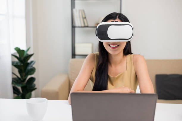 istock Young asian woman put on vr glasses into virtual simulated world. Future technology digital cyber universe. Person Enjoying an Experiences of Virtual World. 1376103688