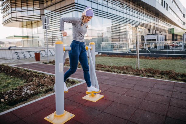 Woman doing exercises on an outdoor device