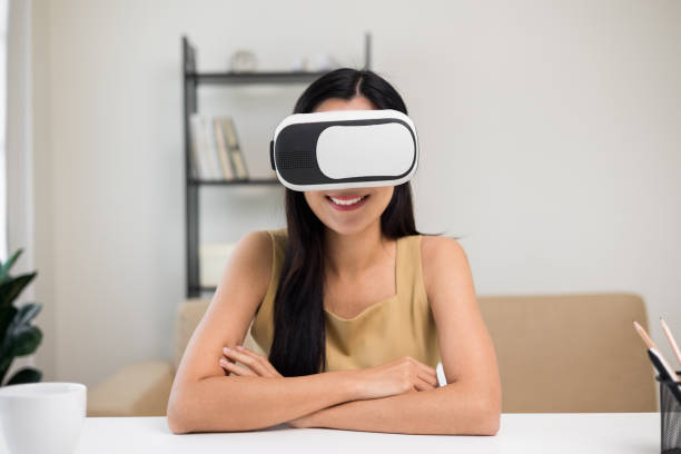 istock Young asian woman put on vr glasses into virtual simulated world. Future technology digital cyber universe. Person Enjoying an Experiences of Virtual World. 1376103858
