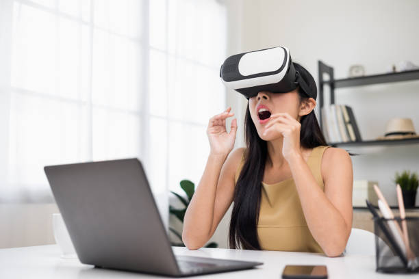 Young asian woman put on vr glasses into virtual simulated world. Future technology digital cyber universe. Person Enjoying an Experiences of Virtual World.