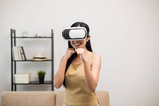 istock Young asian woman put on vr glasses into virtual simulated world. Future technology digital cyber universe. Person Enjoying an Experiences of Virtual World. 1376104113