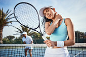 istock Shot of an attractive young woman suffering from a neck injury during tennis practice with her teammate 1376104363