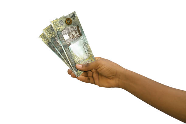 istock Fair hand holding 3D rendered 20 Bahrain dinar notes isolated on white background 1376104467