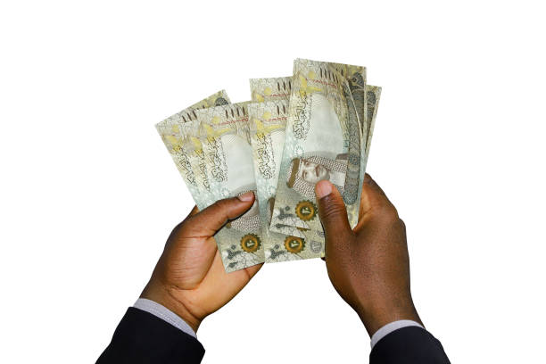 istock Black Hands in suit holding 3D 20 Bahrain Dinar notes 1376104473