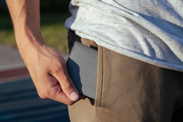 istock The young man puts a gray leather wallet in his back pocket 1376124639